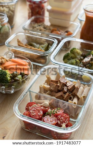 Set of glass jars full of tasty meal displayed in diagonal in a batch cooking scene. Royalty-Free Stock Photo #1917483077