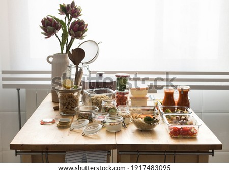 Complete batch cooking scene over a wooden kitchen table. Royalty-Free Stock Photo #1917483095