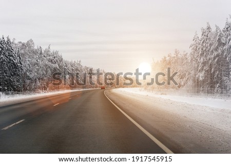 Winter highway. The road leading through the winter landscape. Sunlight. Horizontal photo Royalty-Free Stock Photo #1917545915