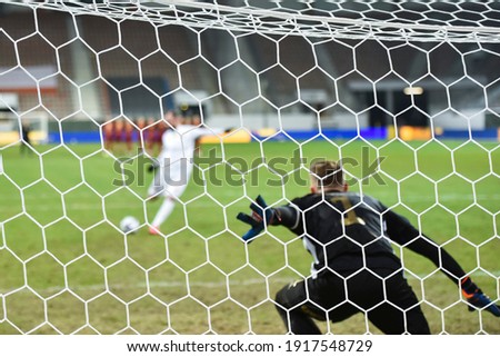Net in the football goal penalty shootout in the background. Royalty-Free Stock Photo #1917548729