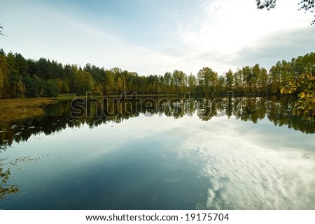 Sky and forest reflected in the lake water