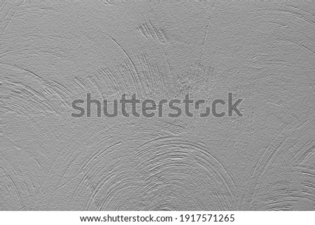 The texture of the plastered gray wall. Decorative plaster with rounded stripes technique.