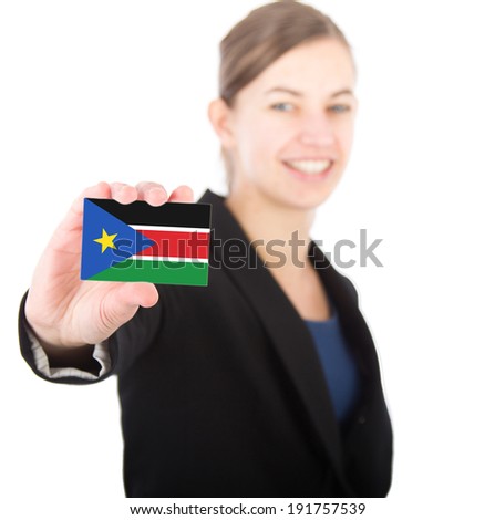 business woman holding a card with the flag of South Sudan. With focus on the card
