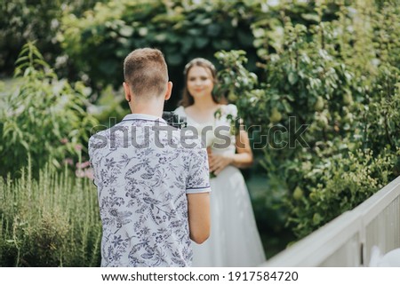 A shallow focus of a young male photographer taking pictures of the bride