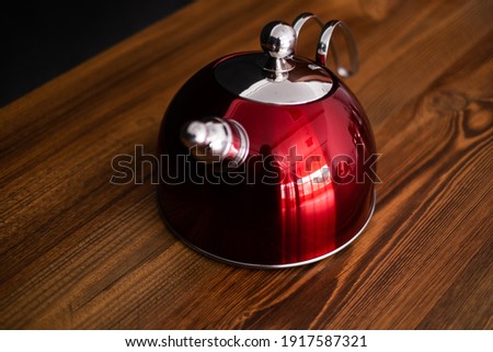 modern Red kettle on wooden background