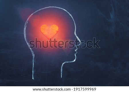 Shining Heart in human head. Love, instinct and romance concept. Chalk drawing. Copy space. Psychology, Valentine day, volunteer symbol. Royalty-Free Stock Photo #1917599969