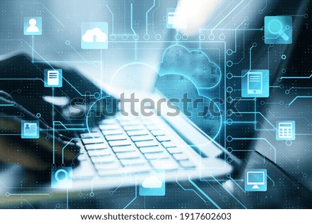 Cloud computer storage concept with digital screen with cloud service application items and fingers on laptop keyboard Royalty-Free Stock Photo #1917602603