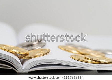 Bitcoins on a book background for finance and stock concept, Investment, Economy, Soft focus.