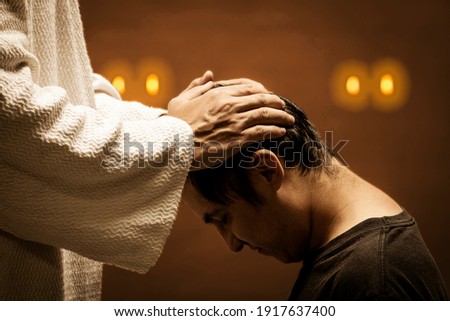 Jesus Christ giving absolution of their sins during a dark night. Royalty-Free Stock Photo #1917637400