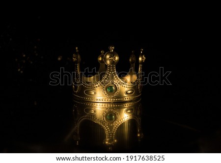 low key image of beautiful queen (or king) crown over wooden table. vintage filtered. fantasy medieval period. Selective focus. Colorful backlight Royalty-Free Stock Photo #1917638525