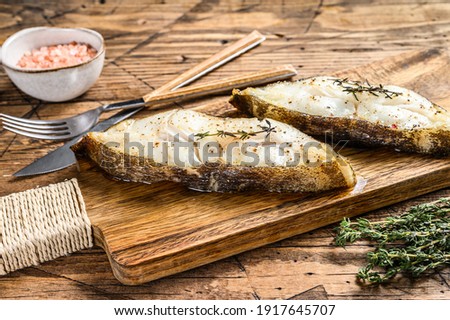 Baked halibut fish steak. wooden background. Top view