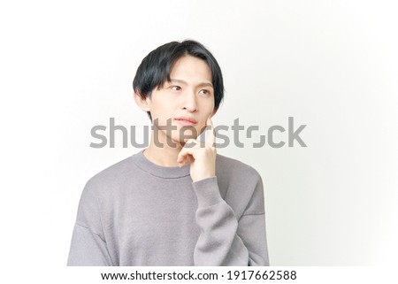 Asian man thinking on white
