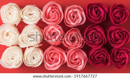 Background of artificial rose buds of three colors. Floral background.