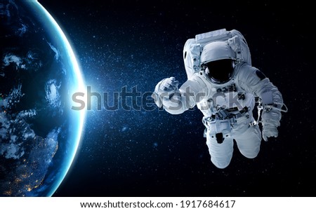 Astronaut spaceman do spacewalk while working for space station in outer space . Astronaut wear full spacesuit for space operation . Elements of this image furnished by NASA space astronaut photos. Royalty-Free Stock Photo #1917684617