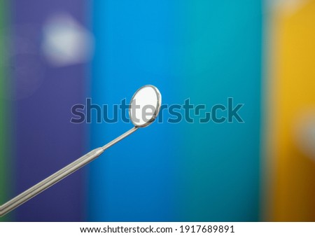 Dental instrument, mirror on colored background