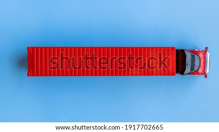 Semi trailer truck lorry container cargo vehicle on blue background, View from above, Aerial top view of semi truck with container cargo, Business logistic and transportation compay. Royalty-Free Stock Photo #1917702665