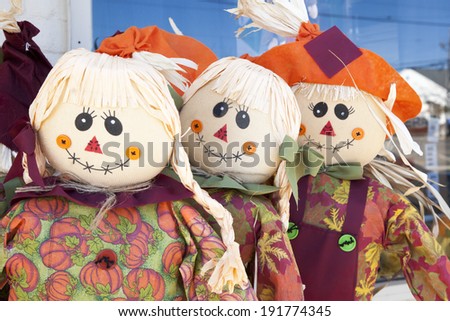 Three scarecrows lined up next to one another