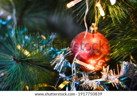 Christmas bulbs and garlands on christmas tree. New Year decoration