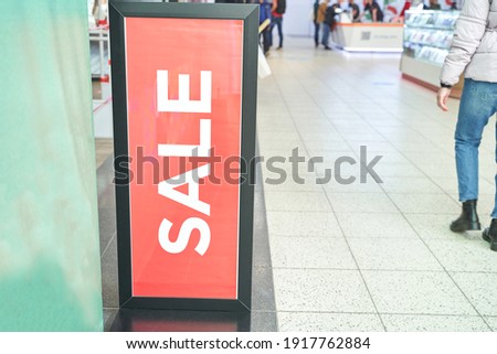 Sale red sign at mall. Discount concept. Market interior design. Selling business model. Lifestyle promotion. Store promo graphic. Shop background. Cheap boutique. Retail commercial price. Money offer