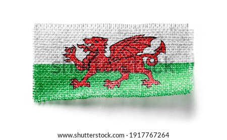 Wales flag on a piece of cloth on a white background