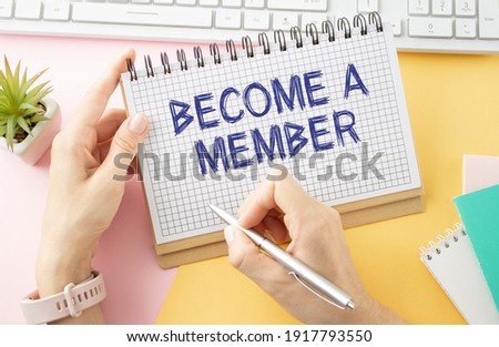 Top angle view of pen and notebook written with text BECOME A MEMBER. Business and education concept
