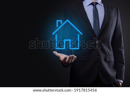 Real estate concept, businessman holding a house icon.House on Hand.Property insurance and security concept. Protecting gesture of man and symbol of house