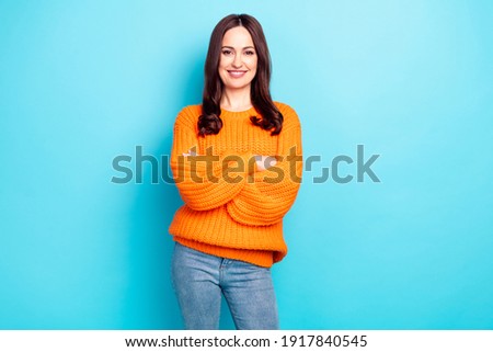Portrait of gorgeous friendly person crossed hands toothy smile wear oversize pullover isolated on blue color background