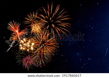Fireworks with blur milky way background Royalty-Free Stock Photo #1917860657