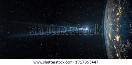 Comet, asteroid, meteorite flying to the planet Earth on the starry night sky. Asteroid and tail of a falling comet threatening the safety of the Earth. Elements of this image furnished by NASA. 