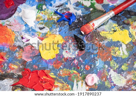 Painter's palette stained with many colors