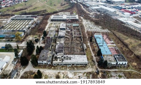 Aerial drone view of burned and abandoned industrial complex. Former factory. Remnants of burnt down building. Fire damage. Damaged industrial halls.