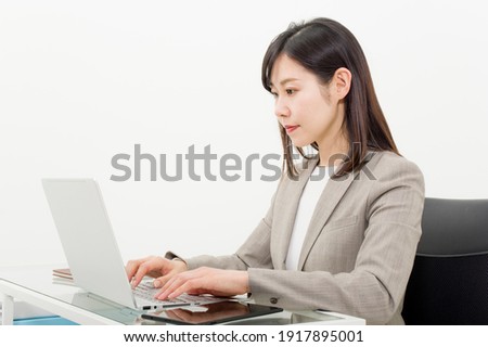 A woman who works with a computer in the office Royalty-Free Stock Photo #1917895001