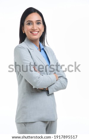 Confident Businesswoman against white background.