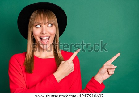 Portrait of young attractive pretty excited crazy happy girl pointing fingers copyspace isolated on green color background