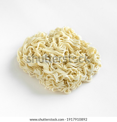 Instant noodles isolated on white background. Uncooked raw Asian noodles