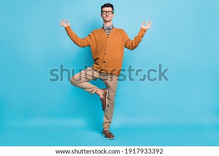 Full length photo of calm young man yoga make om sign rest relax isolated on pastel blue color background