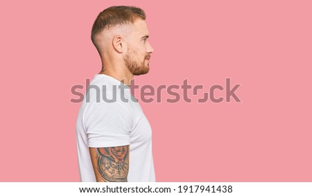Young irish man wearing casual clothes looking to side, relax profile pose with natural face with confident smile. 