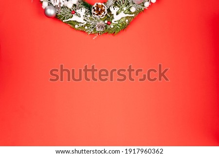 Minimalistic stylish background for design free space on a red background Christmas and New Year wreaths and toys
