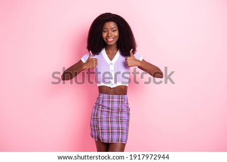 Portrait of lovely cheerful wavy-haired girl showing thumbup agree ad cool decision isolated over pink pastel color background