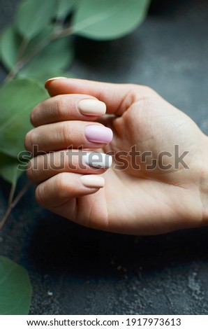 Women's hands with colorful pattern on the nails. 2021 colors trend. Top view. Place for text. Spring nails concept.
