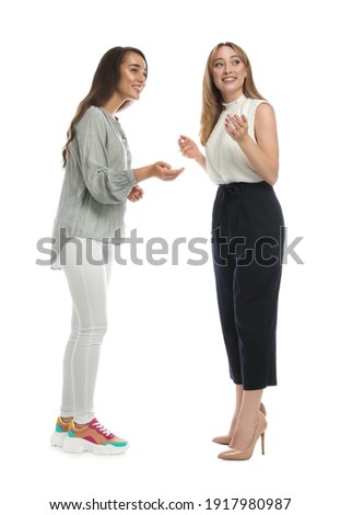 Young women in casual clothes talking on white background