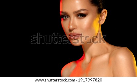 Portrait beautiful attractive girl with natural makeup, smooth straight hair. isolated on black background. beauty passion woman with expressive look. eye and lip makeup. salon care skin hair eyebrows