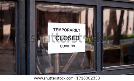 The sign in front of the office is temporarily closed. Sign Coronavirus in the store Royalty-Free Stock Photo #1918002353