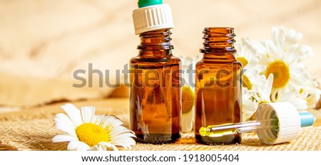 chamomile extract in a small bottle on sacking. selective focus. nature 