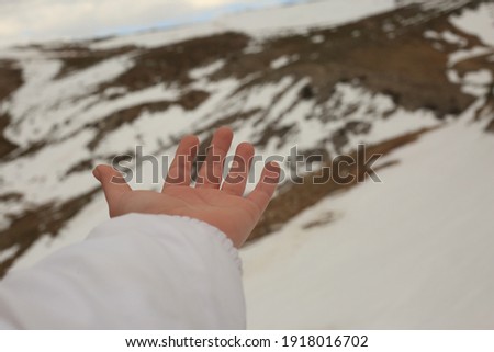 snowy landscape and hand photograph