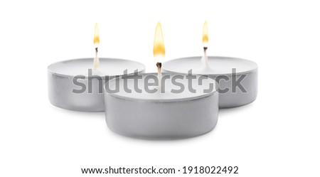 Three small wax candles isolated on white Royalty-Free Stock Photo #1918022492