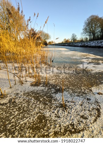 Water channel with ice and snow in winter