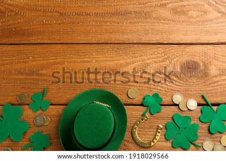 Leprechaun's hat and St. Patrick's day decor on wooden background, flat lay. Space for text