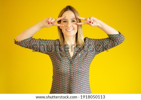 Young woman over isolated background smiling and showing victory sign