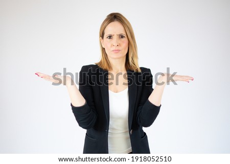 Beautiful young woman wearing casual shirt over isolated background clueless and confused expression with arms and hands raised. Doubt concept.